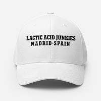 a white baseball cap with a black text on it that says latic acid junkies madrid spain